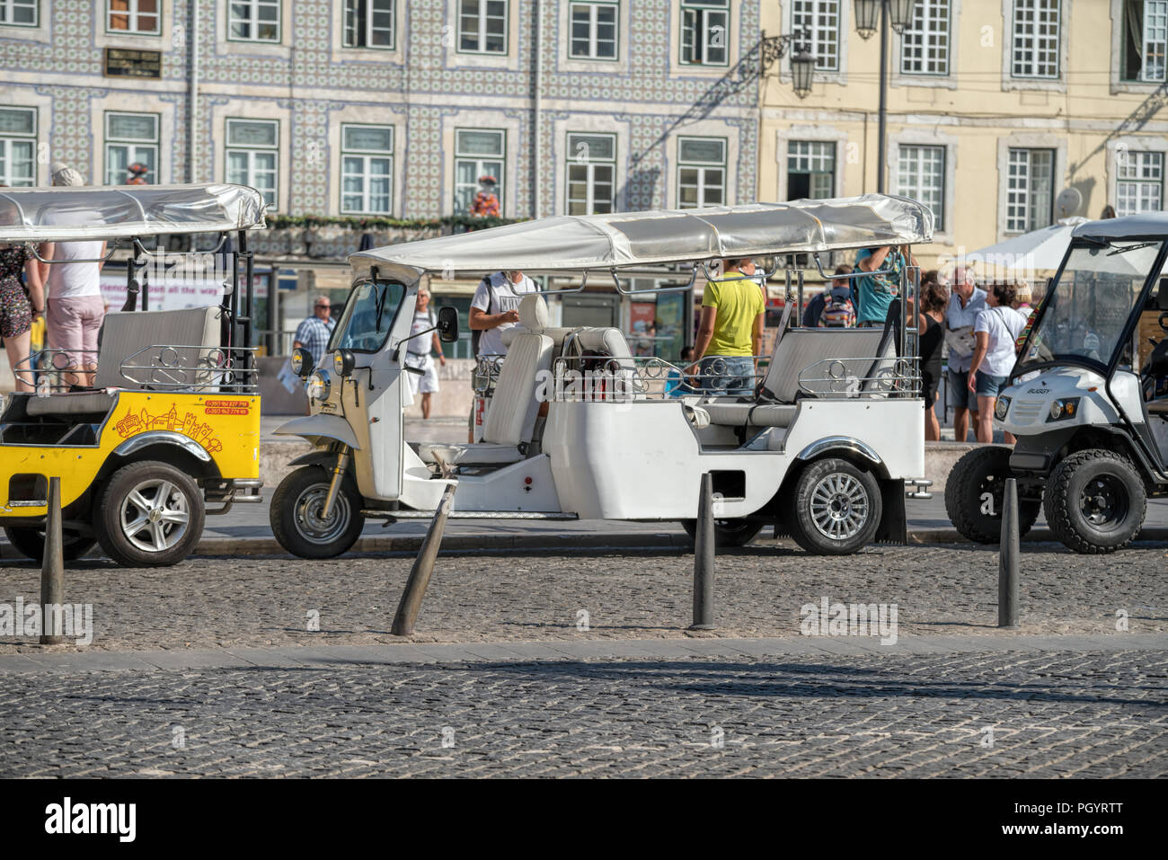 Tuk tuks in front of the statue of King John . Traditional taxi on Thailand and popular Tourist transportation at Lisbon. Stock Photo