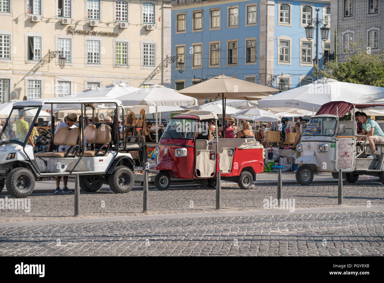 Tuk tuks in front of the statue of King John . Traditional taxi on Thailand and popular Tourist transportation at Lisbon. Stock Photo