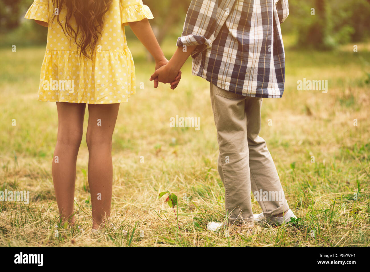 Boy and girl holding hands Stock Photo - Alamy