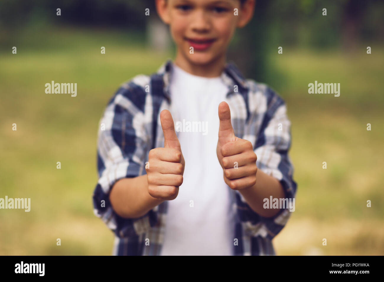 Little boy showing thumbs up Stock Photo - Alamy
