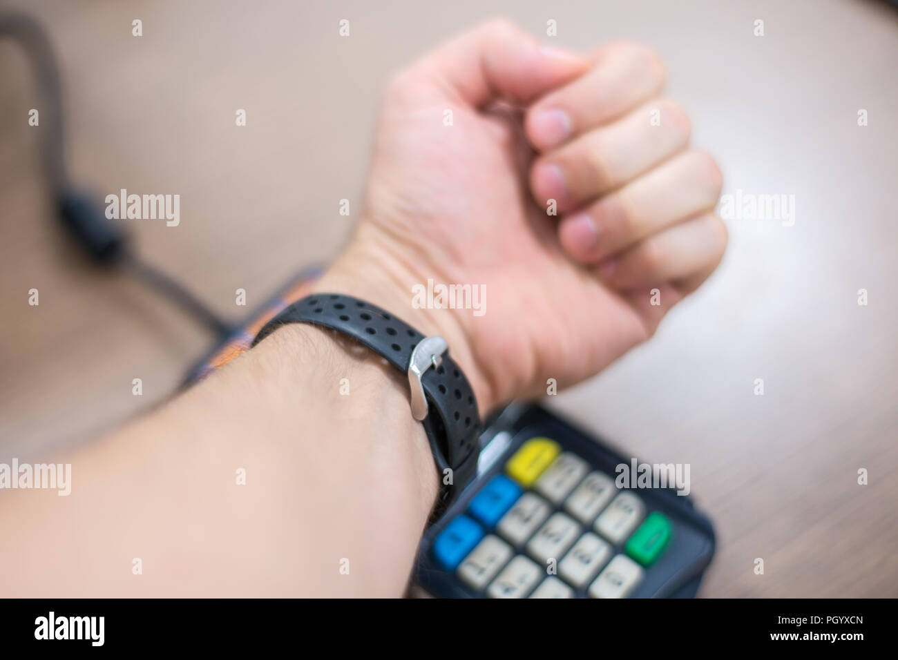 Contact less payment. Paying with smart bracelet. Payment system on wearable bracelet devices concept. Stock Photo