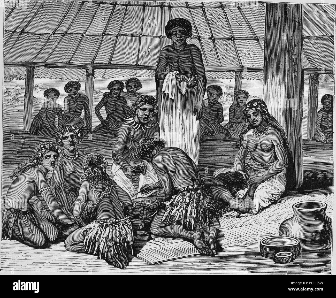Black and white vintage print, depicting a Samoan boy lying prone on the ground while his body is tattooed by an artist who leans over him in the foreground, an attendant standing in the background holds a white masi cloth, and various women surround him, both to hold him down and soothe him, including his sister, who wears taE>>ovala (mat) wrapped around her waist, necklaces, and shells in her hair, and holds her brother's head and hands in her lap, published in John George Wood's volume 'The uncivilized races of men in all countries of the world, being a comprehensive account of their manner Stock Photo