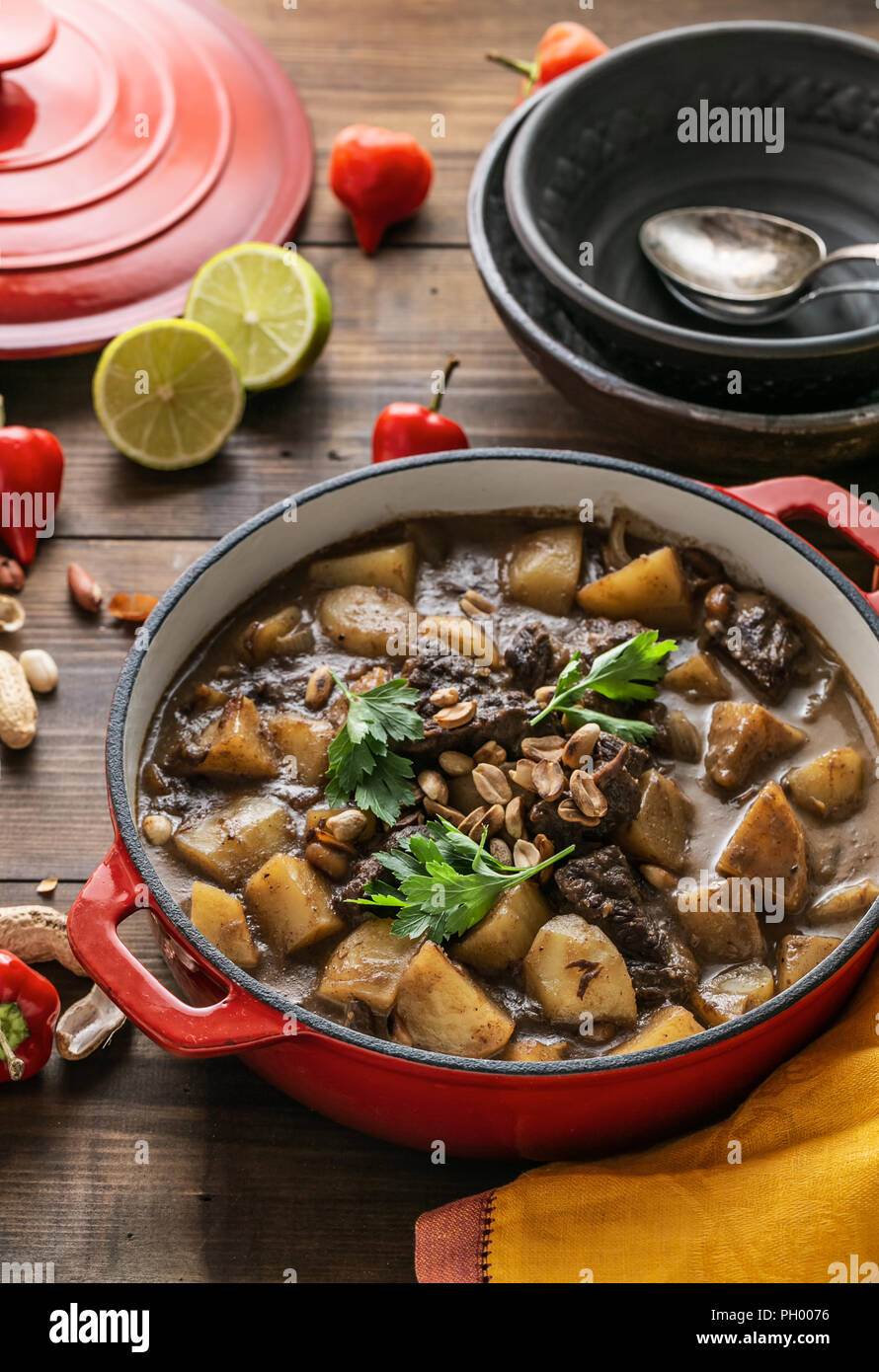 Thai Beef Massaman Curry served in big red pot, top view Stock Photo