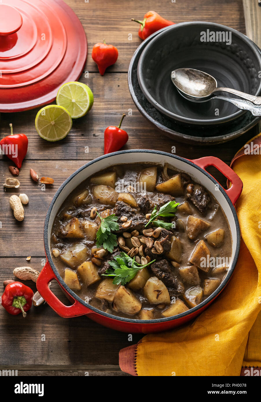Thai Beef Massaman Curry served in big red pot, top view Stock Photo