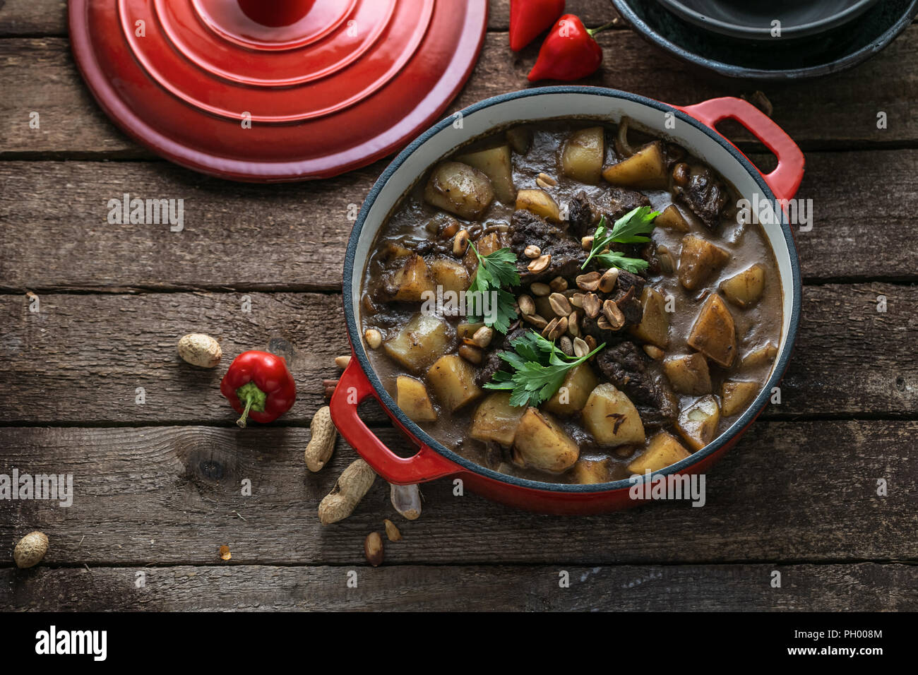 Famous thai dish massaman curry in red pan Stock Photo