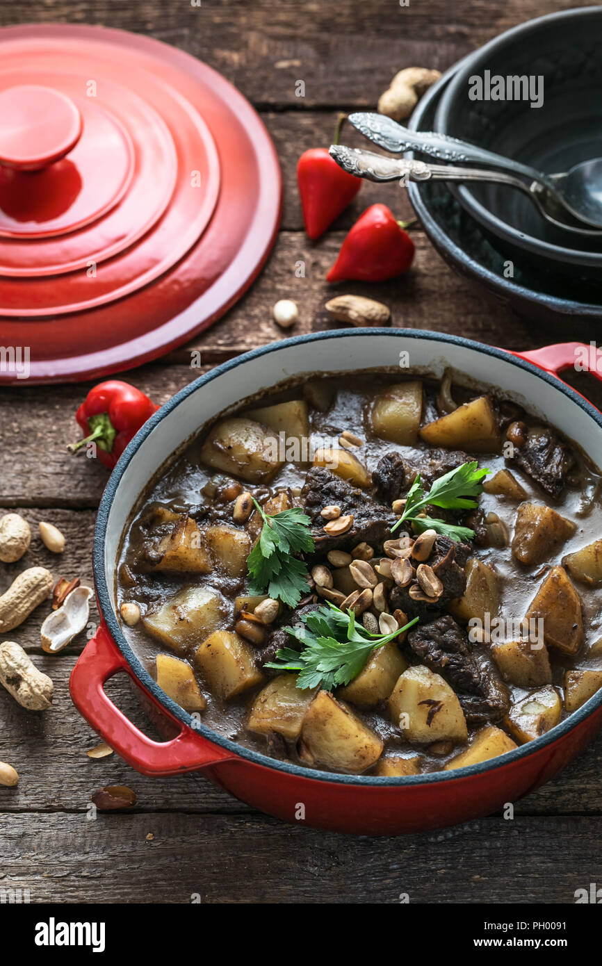 Famous thai dish massaman curry in red pan Stock Photo