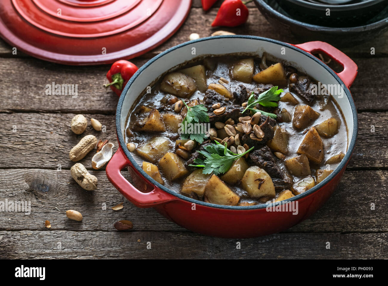 Famous thai dish massaman curry in red pan Stock Photo