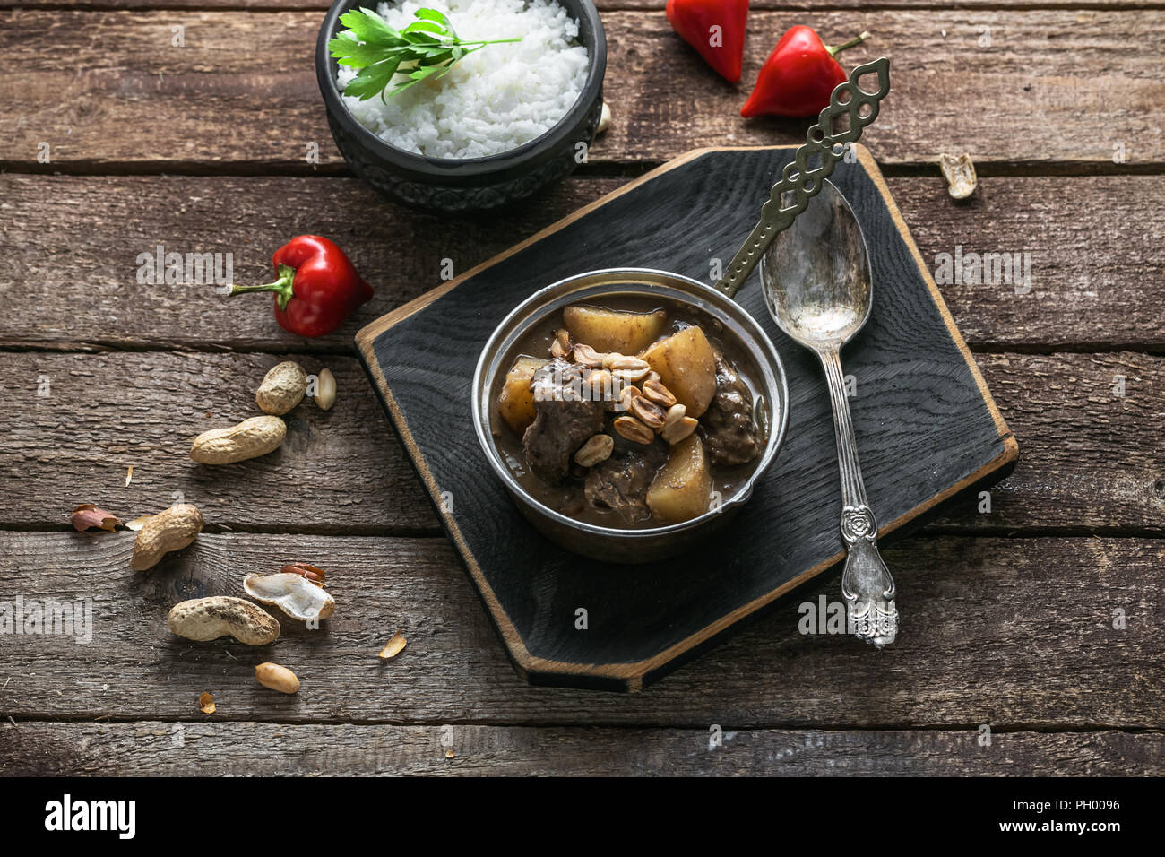 Thai Beef Massaman Curry with Rice, dark background copy space Stock Photo