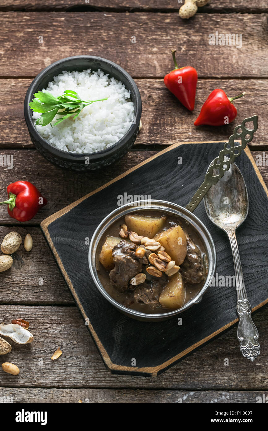 Thai Beef Massaman Curry with Rice, dark background copy space Stock Photo