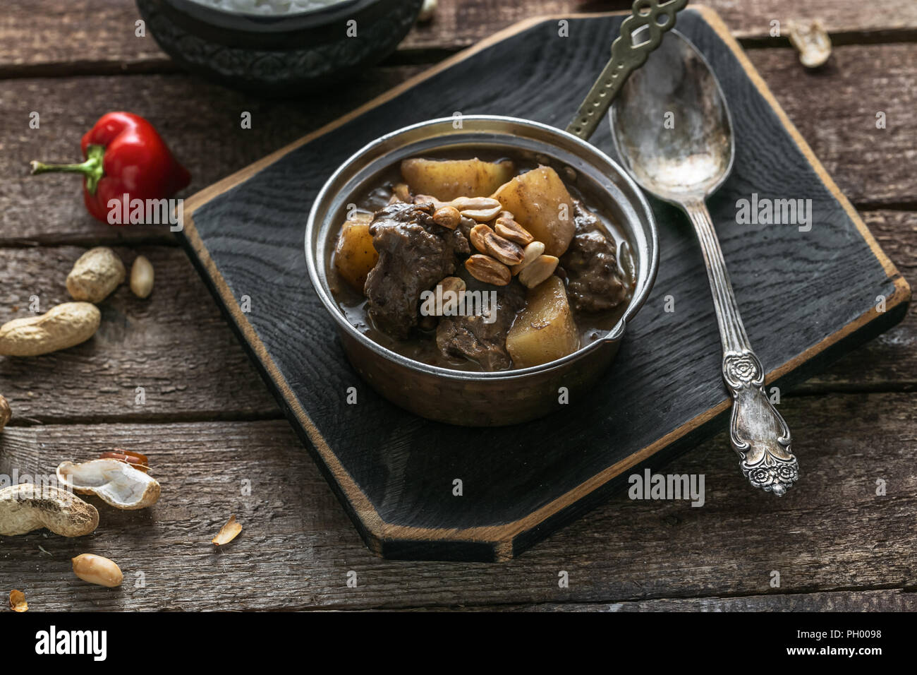 Thai Beef Massaman Curry with Rice, dark background copy space Stock Photo