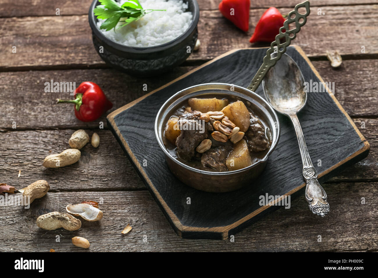 Thai Beef Massaman Curry with Rice, dark background copy space Stock Photo