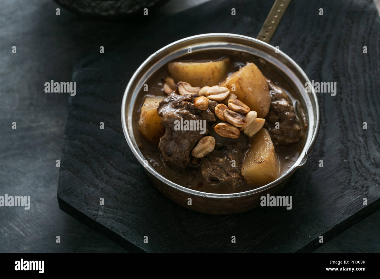 Close view of Massaman Curry with Rice, dark background copy space Stock Photo