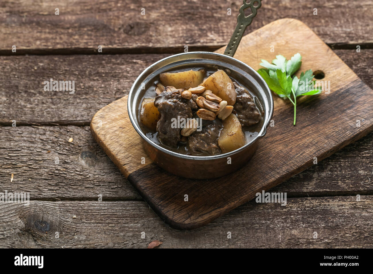Thai Muslim beef curry or massaman curry served in copper pan Stock Photo
