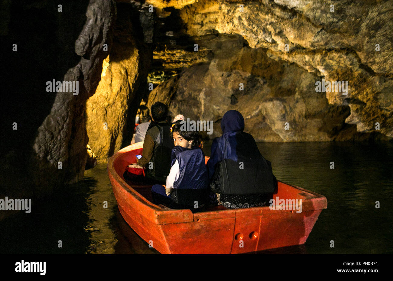 Hamedan, Iran. 27th Aug, 2018. Tourists visit Alisadr cave on a boat in Hamedan province, western Iran, on Aug. 27, 2018. Alisadr Cave attracts thousands of tourists every year. Credit: Ahmad Halabisaz/Xinhua/Alamy Live News Stock Photo