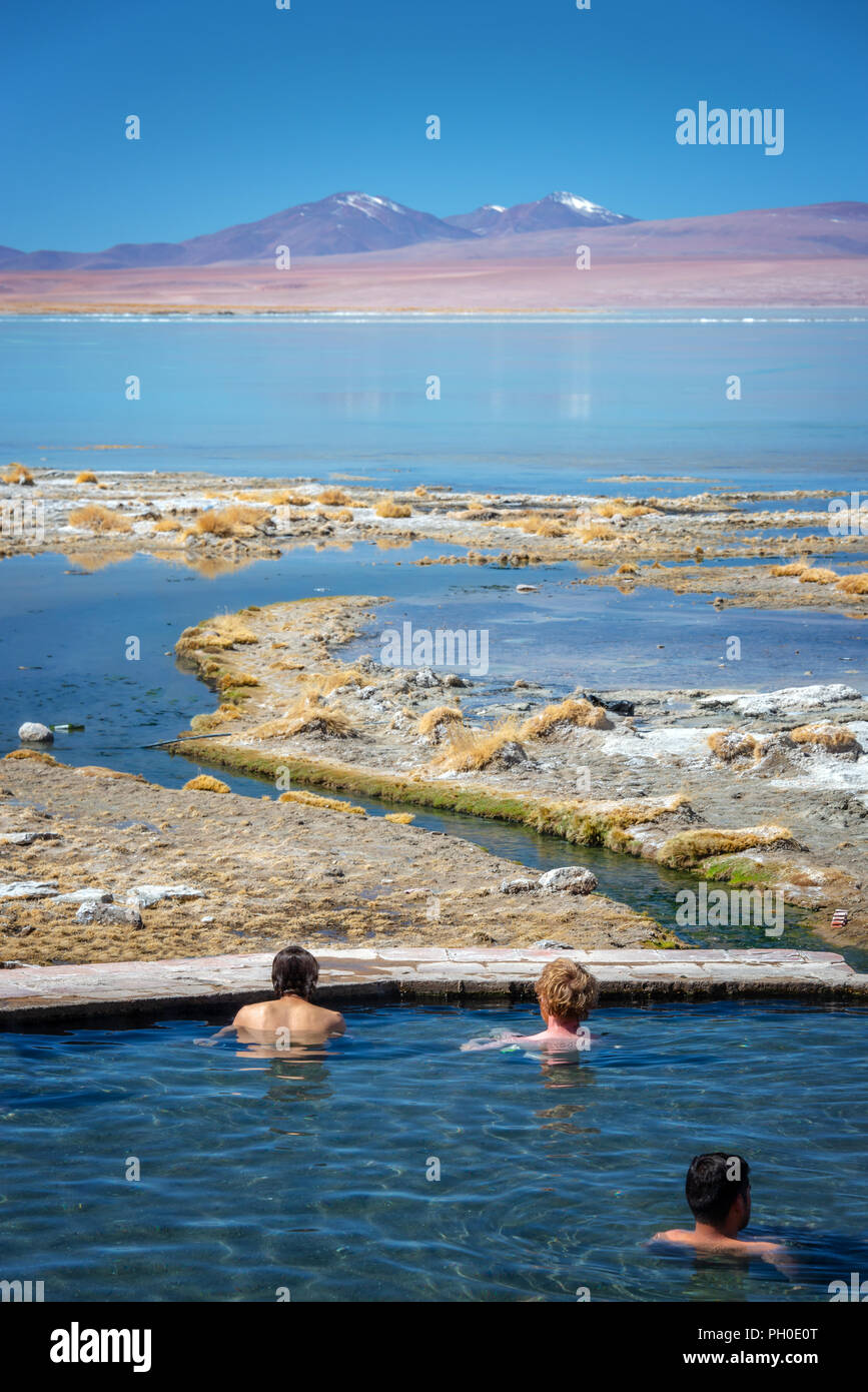Tourists enjoying a bath in the hot springs of Laguna Polques, Sud Lipez province, Potosi, Bolivia Stock Photo