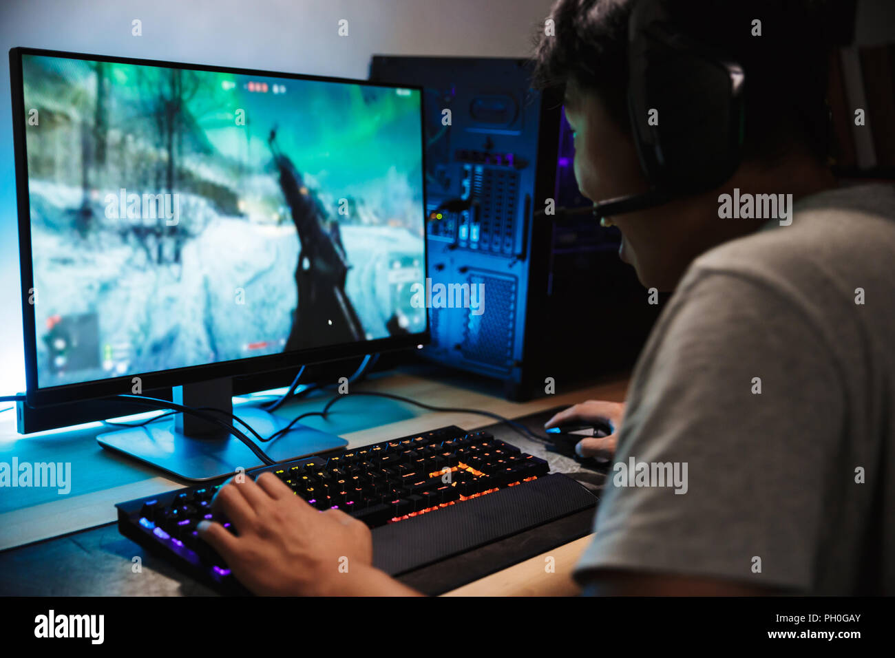 Boy play game on gaming PC online Stock Photo - Alamy