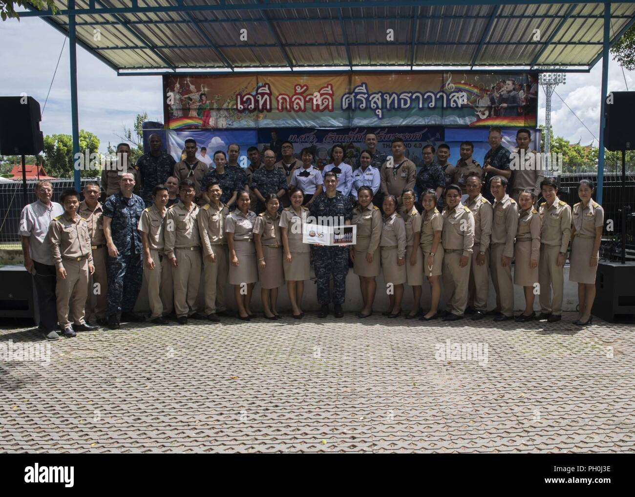 Thailand (June 14, 2018) - The 7th Fleet Band, the Royal Thai Navy Band and and Thai government officials pose for a group following a group performance at the Wat Sutthawat School in support of Cooperation Afloat Readiness and Training (CARAT) Thailand 2018. The CARAT exercise series, in its 24th iteration, highlights the skill and will of regional partners to cooperatively work together towards the common goal of ensuring a secure and stable maritime environment. Stock Photo