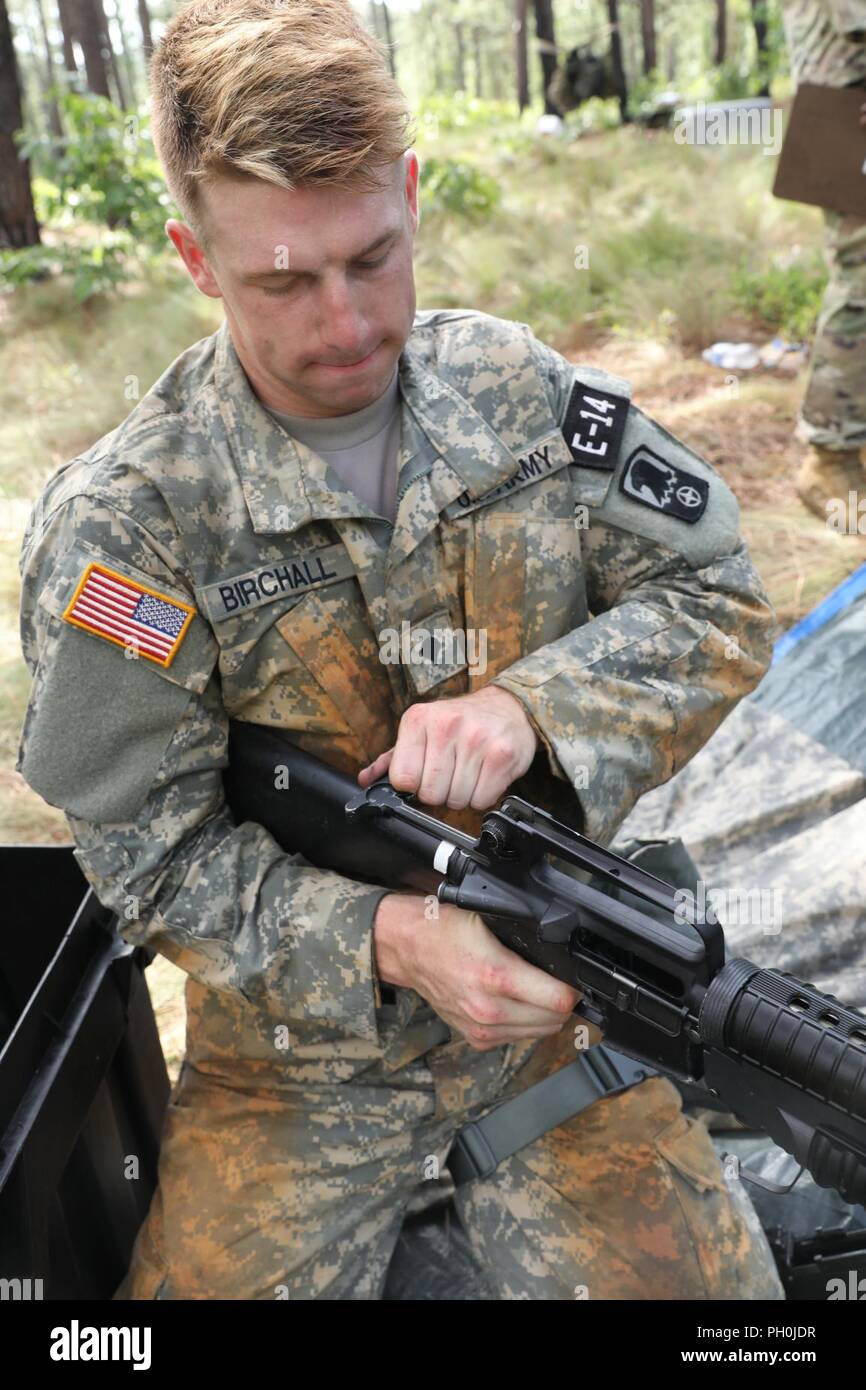 U.S. Army Reserve Spc. Dawson Birchall, an aviation operations specialist from Howell, New Jersey, with the 244th Expeditionary Combat Aviation Brigade, U.S. Army Reserve Aviation Command, performs a functions check during a weapons assembly/disassembly event at the 2018 U.S. Army Reserve Best Warrior Competition at Fort Bragg, North Carolina, June 14, 2018. Today, U.S. Army Reserve Soldiers give everything they have to push past their limits and finish the last day of events in the 2018 U.S. Army Reserve Best Warrior Competition. Stock Photo