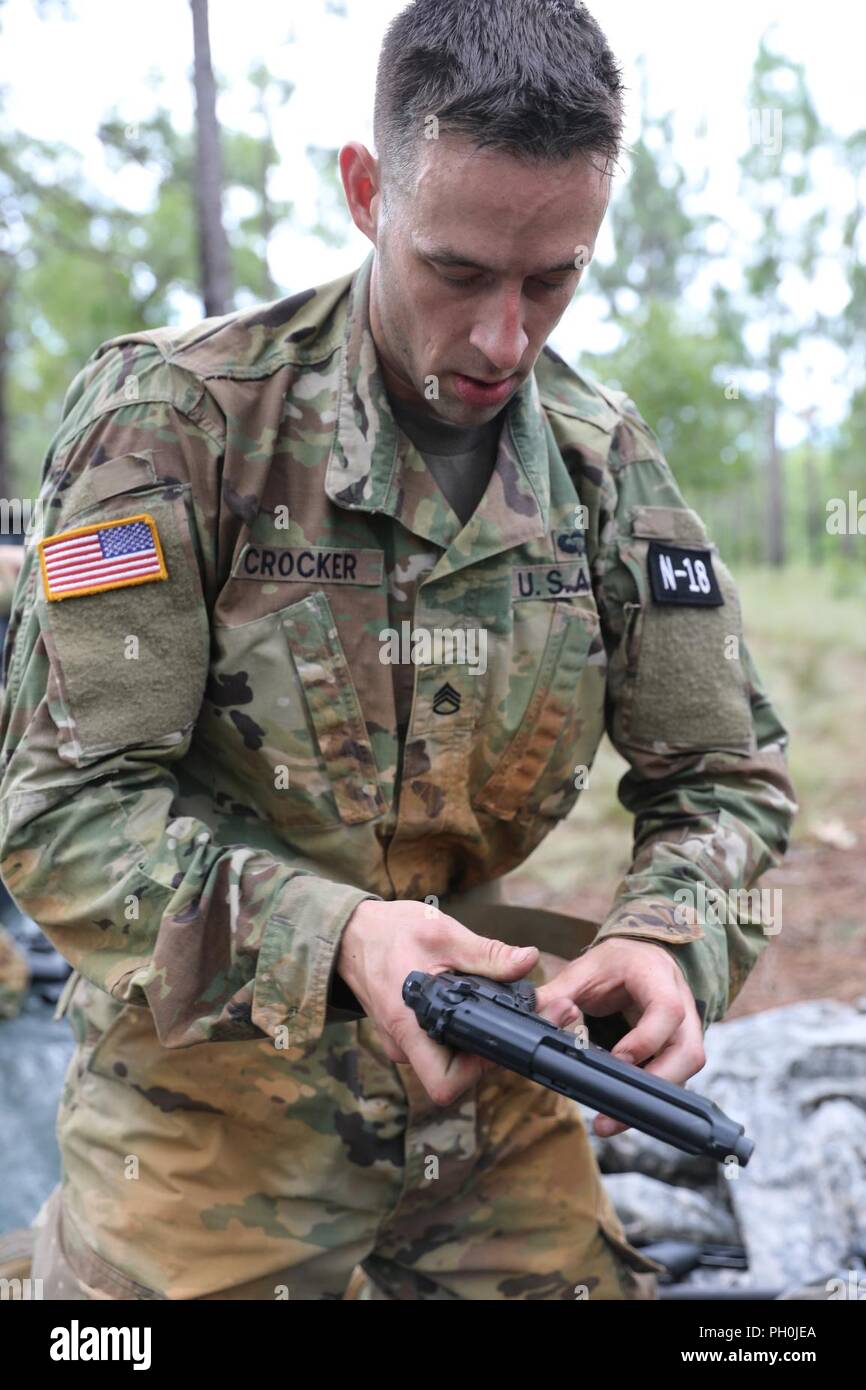 U.S. Army Reserve Staff Sgt. Michael Crocker, a paralegal noncommissioned officer from Woodbridge, Virginia, with the 151st Legal Operations Detachment, United States Army Reserve Legal Command, assembles a M9 during the weapons assembly/disassembly event at the 2018 U.S. Army Reserve Best Warrior Competition at Fort Bragg, North Carolina, June 14, 2018. Today, U.S. Army Reserve Soldiers give everything they have to push past their limits and finish the last day of events in the 2018 U.S. Army Reserve Best Warrior Competition. Stock Photo