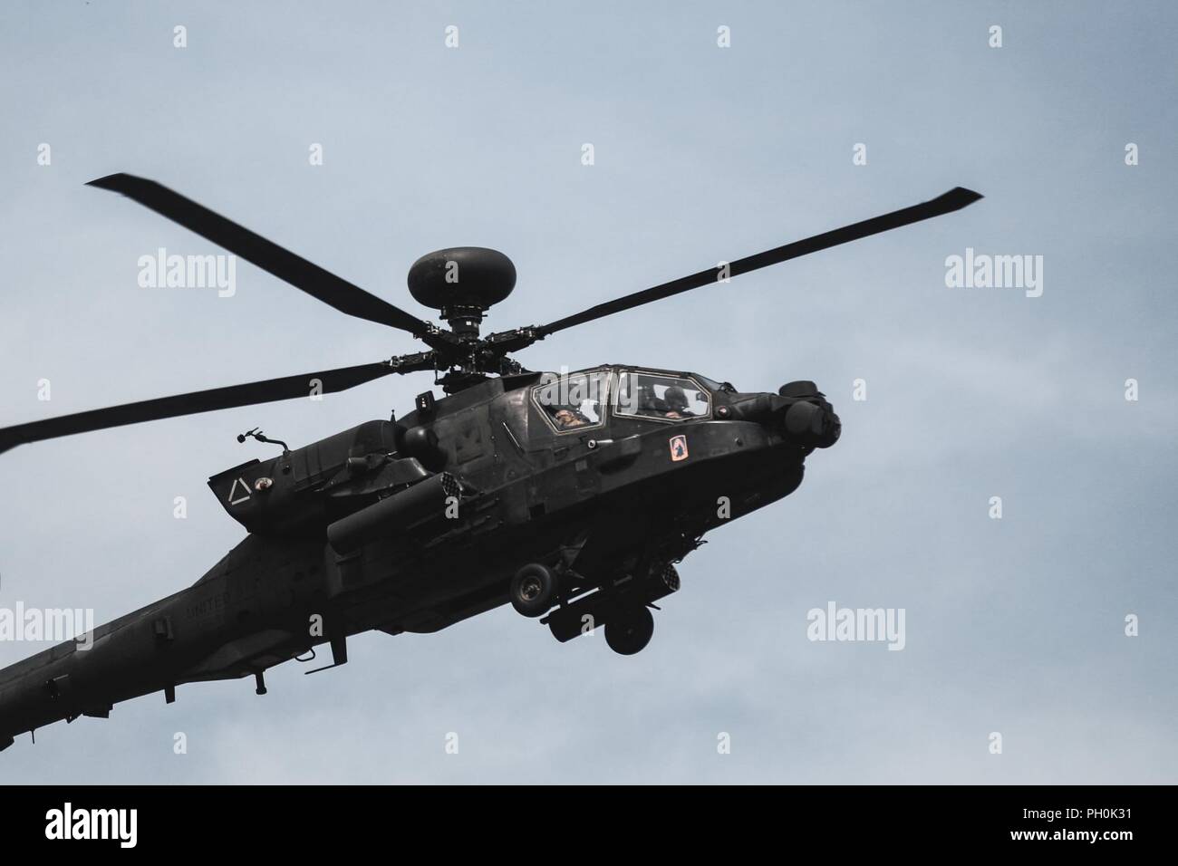 A U.S. Army AH-64 Apache helicopter with Battle Group Poland, provides  aerial support for Polish soldiers with 15th Mechanized Brigade, during a  lethality demonstration for exercise Puma 2 with Battle Group Poland