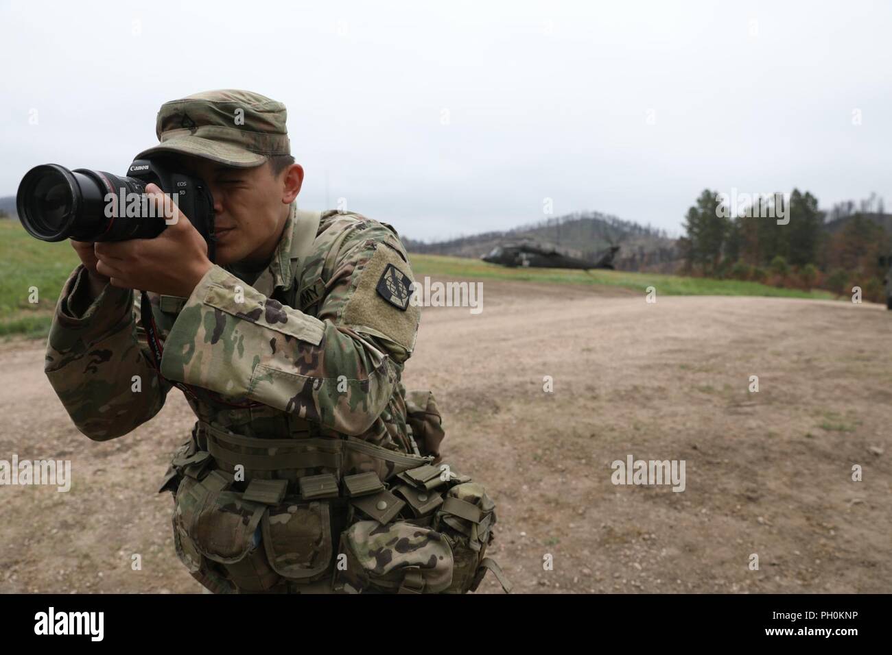 U.S. Army Pfc. James Smith documents a Mass Casualty training event in support of Golden Coyote, Custer State Park, S.D., June 16, 2018. The Golden Coyote exercise is a three-phase, scenario-driven exercise conducted in the Black Hills of South Dakota and Wyoming, which enables commanders to focus on mission essential task requirements, warrior tasks and battle drills. Stock Photo