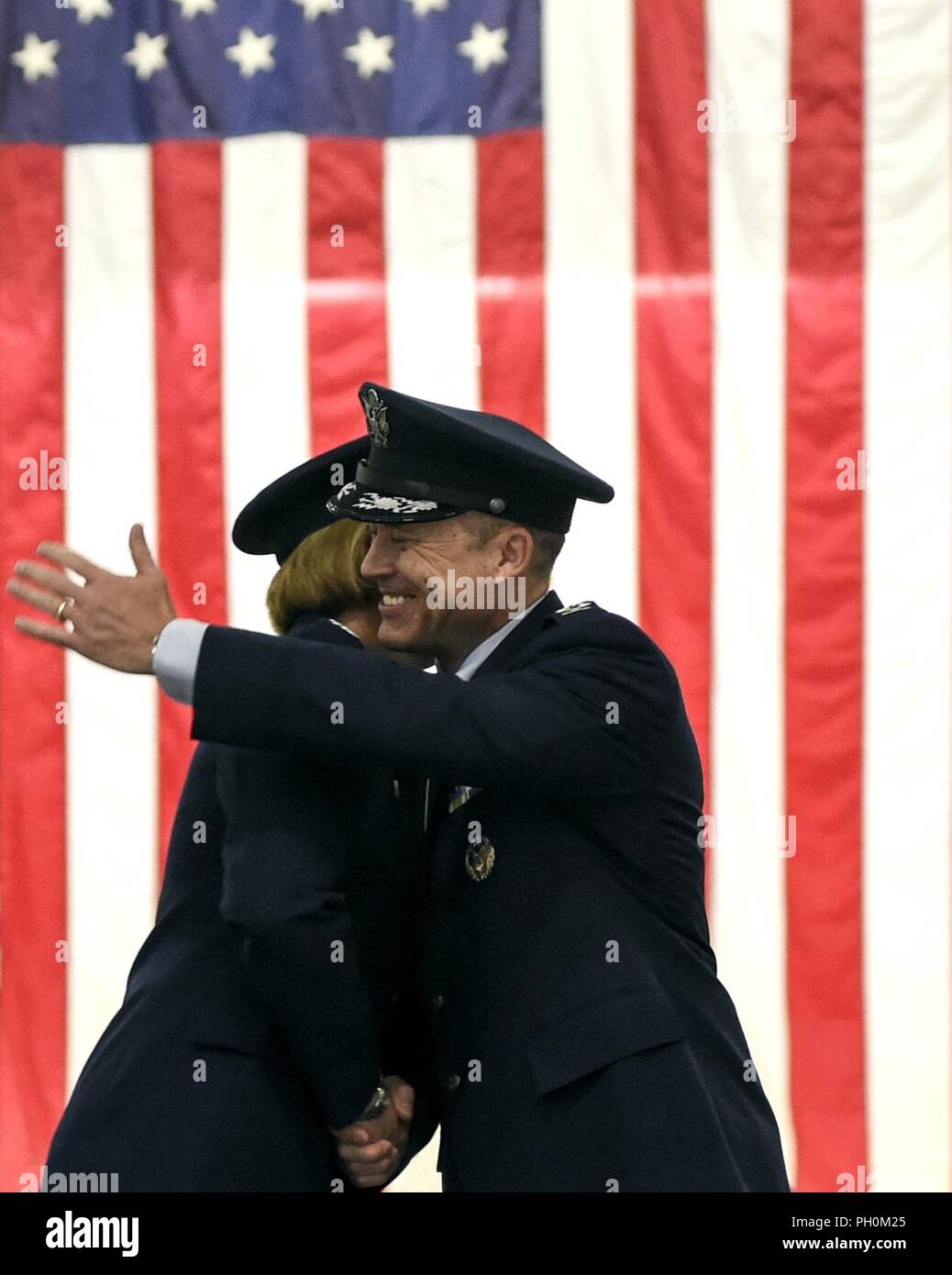 Col. Rebecca Sonkiss, 89th Airlift Wing commander is congratulated by Col Casey Eaton, former 89th AW commander, June 15, 2018 during a change of command ceremony at Joint Base Andrews, Md. Sonkiss assumed command of the 89th AW from Eaton. Sonkiss is a command pilot with more than 4,200 hours in the T-37B, T-44, EC-130/H, RQ-1A/B, C-130J and C-17 aircraft. She has 24 years of active-duty service and arrived at JBA from Joint Base Lewis-McCord, Wash. where she was the 62nd Airlift Wing commander. Stock Photo