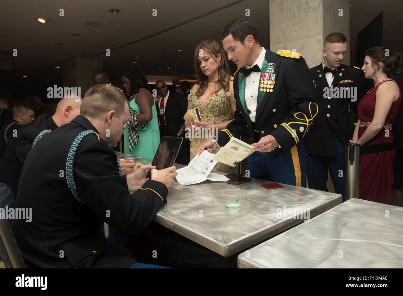 Guests attending the 243rd Army Birthday Ball at the Washington Hilton Hotel in Washington, D.C., June 16, 2018 check in upon arrival. Stock Photo