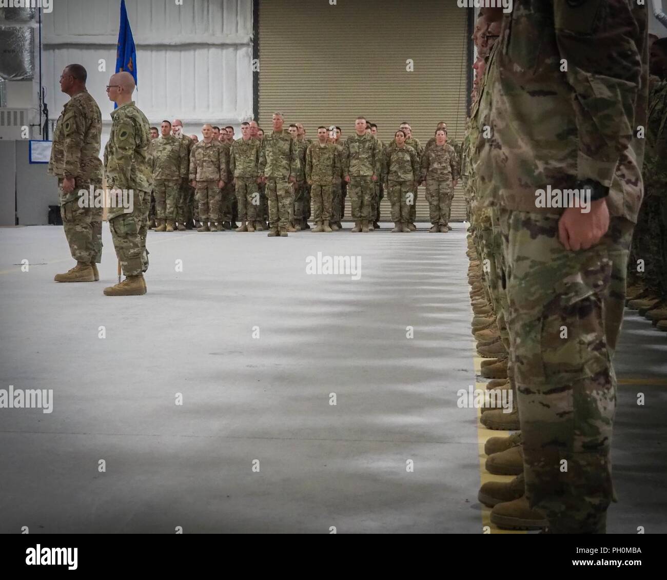 U.S. Army National Guard Soldiers from B. Co., 935th Aviation Support Battalion, 35th Combat Aviation Brigade (CAB), based in Kankakee, Ill., stand at attention during the shoulder-sleeve insignia change ceremony at North Fort Hood, Texas, June 15, 2018.  Bravo company unifies in preparation for a deployment with the 35th CAB. Stock Photo