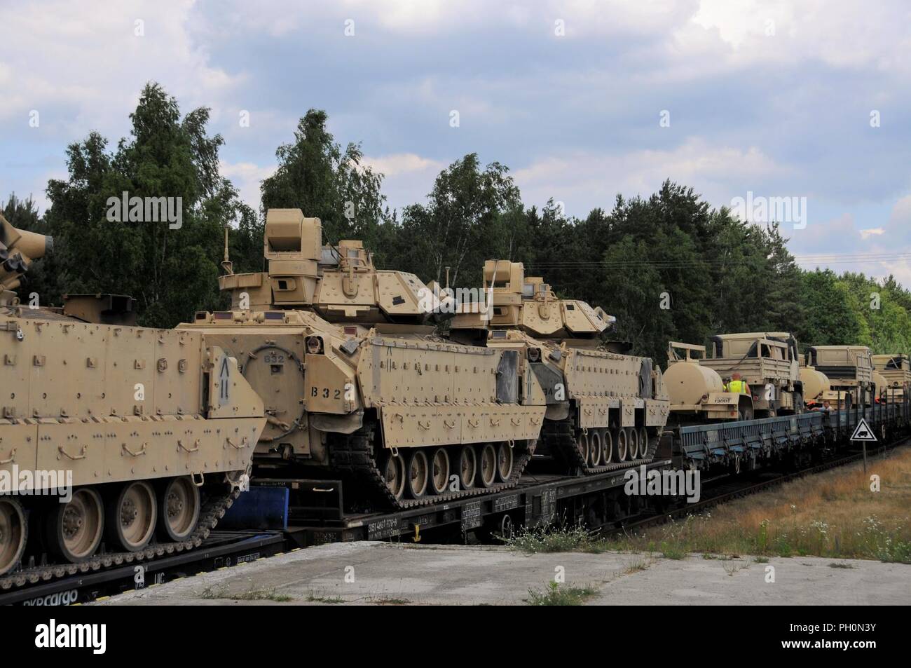 U.S. Soldiers from the 2nd Battalion, 5th Cavalry Regiment, 1st Armored Brigade Combat Team, 1st Cavalry Division, rail load their vehicles and equipment during Atlantic Resolve at Zagan, Poland, June 18, 2018. Atlantic Resolve is a demonstration of continued U.S. commitment to collective security through a series of actions designed to reassure NATO allies and partners of America's dedication to enduring peace and stability in the region. Stock Photo