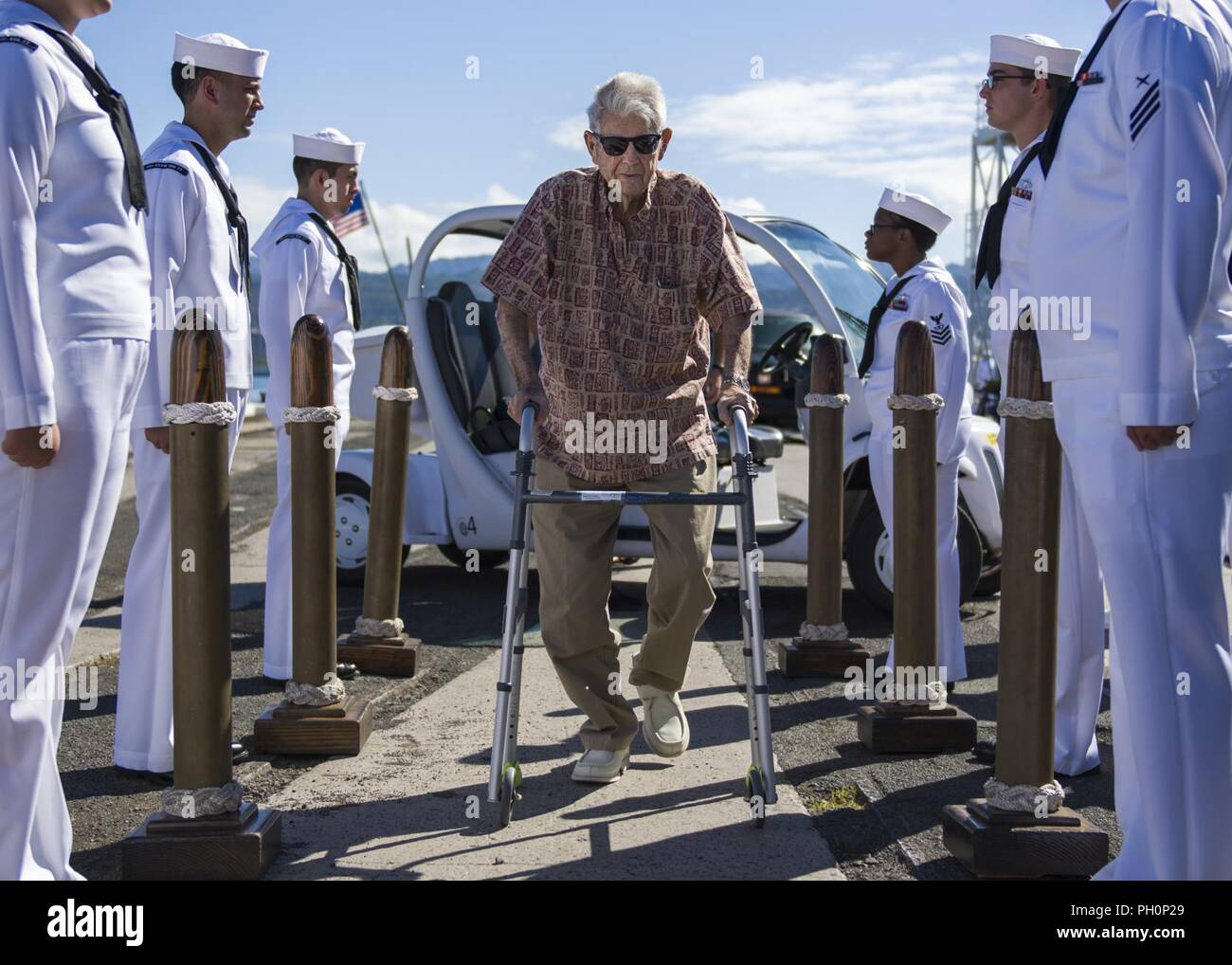 PEARL HARBOR (June 19, 2018) Retired Chief Boatswain's Mate and Pearl Harbor survivor Ray Emory is rendered honors by the sideboys during a farewell ceremony held before he departs Hawaii to be with family. Emory was responsible for the identification of unknown service members killed in the attacks on Pearl Harbor who were buried in unnamed graves. Stock Photo