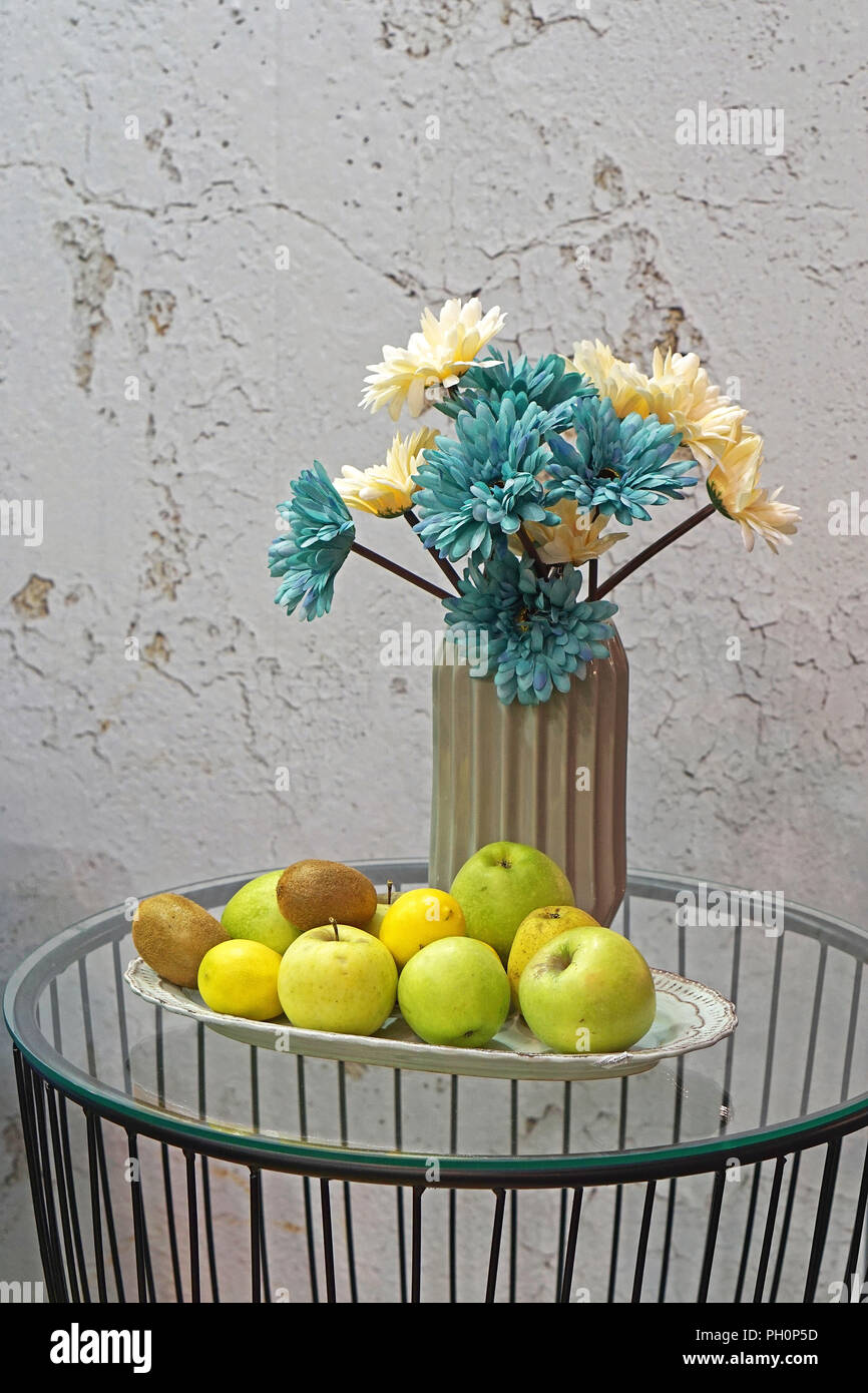 Flowers in vase and fruits at tray still life Stock Photo - Alamy