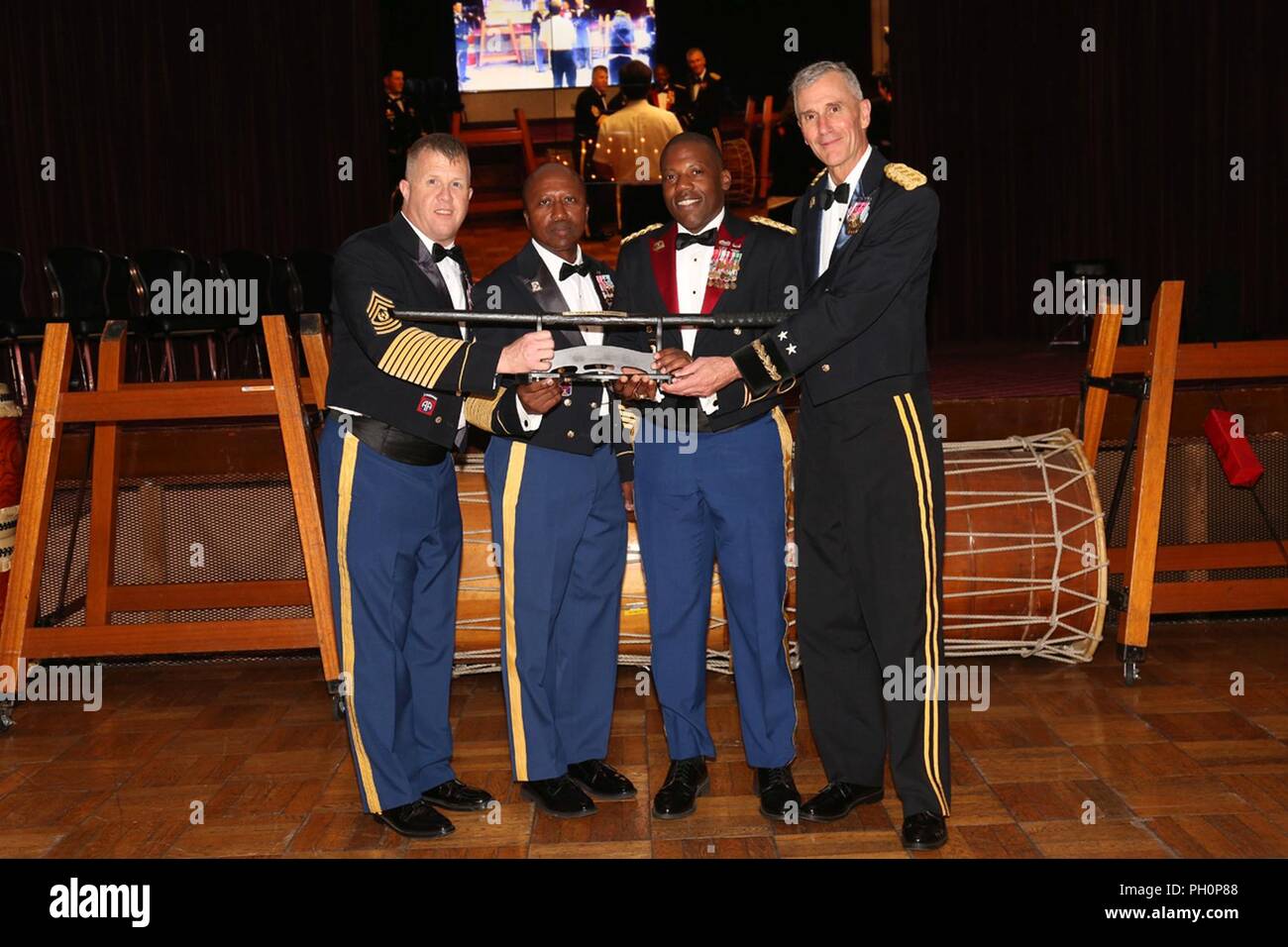 The 35th Combat Sustainment Support Battalion receives first place in the Commander’s Cup Competition for having the most wins as a unit during the Army Birthday Ball held June 14, 2018 at Camp Zama Community Club. Pictured from left to right are: Command Sgt. Maj. Richard Clark, command sergeant major of U.S. Army Japan, Command Sgt. Maj.  Kenneth Law, command sergeant major of 35th CSSB, and Maj. Gen. James Pasquarette, commanding general of USARJ. Stock Photo