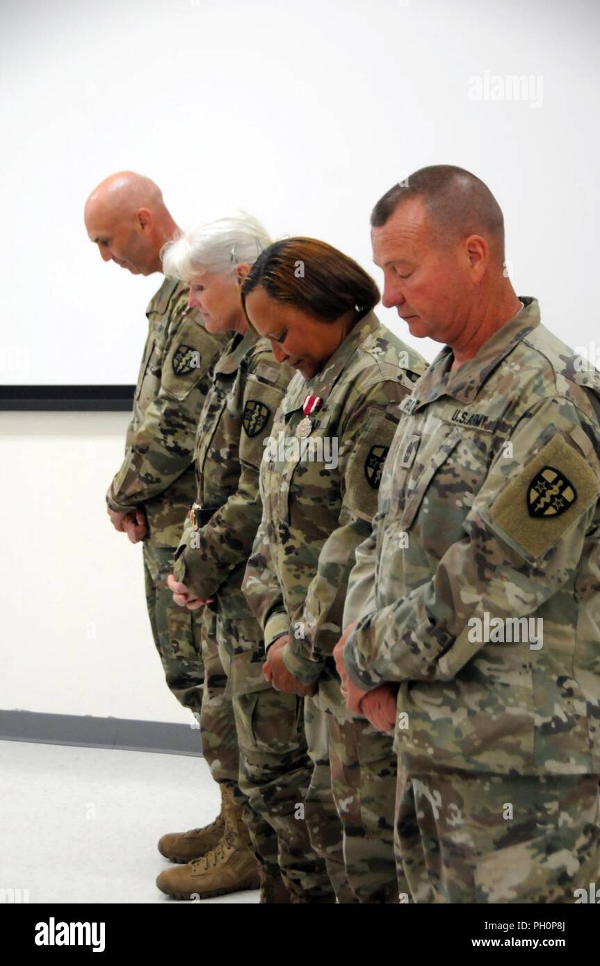 The official party bowed their heads for benediction during the Army Medical Department Professional Management Command Change of Command ceremony held on Monday, June 18, 2018 in Forest Park, Georgia.  U.S. Army Reserve Col. Todd Traver assumed command of from Col. Regina Powell, the outgoing commander, during the ceremony presided over by Army Reserve Medical Command commanding general, Maj. Gen. Mary Link. The Change of Command ceremony symbolizes the continuation of leadership and unit identity despite the change of individual authority. It also represents the transfer of power from one le Stock Photo