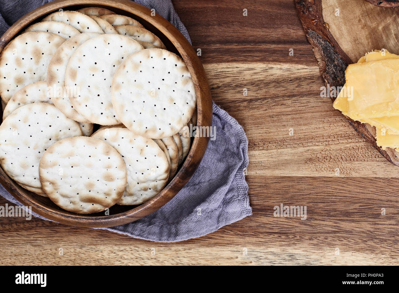 Overhead shot of a bowl of water crackers and sliced cheddar cheese