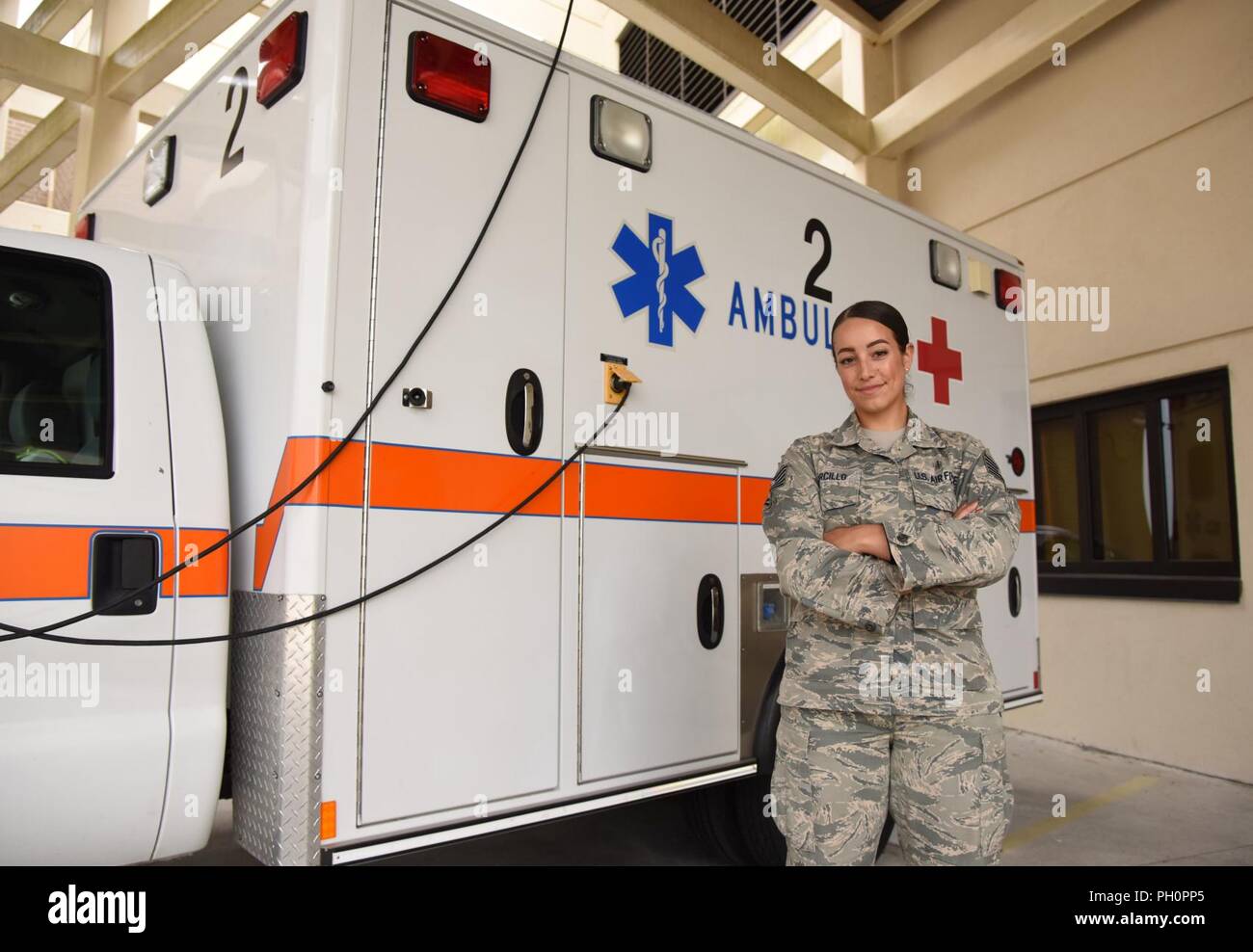 U.S. Air Force Tech. Sgt. Juliet Corcillo, 81st Medical Operations Squadron emergency room NCO in charge, poses for a photo in front of an ambulance outside of the Keesler Medical Center emergency room at Keesler Air Force Base, Mississippi, June 14, 2018. Corcillo was awarded a full ride scholarship to medical school from the Air Force’s Health Professions Scholarship Program. Stock Photo