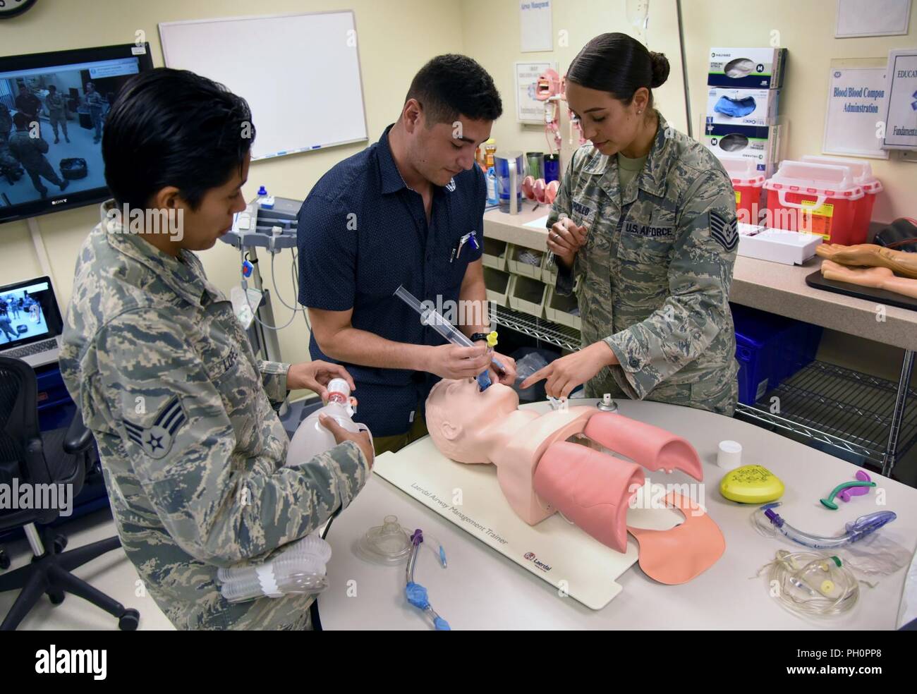 U.S. Air Force Tech. Sgt. Juliet Corcillo, 81st Medical Operations Squadron emergency room NCO in charge, conducts a respiratory training session with Senior Airman Lupita Lopez, 81st Aerospace Medicine Squadron medical technician, left, and Airman 1st Class Enrique Padron, 81st MDOS medical technician, in the Keesler Medical Center at Keesler Air Force Base, Mississippi, June 14, 2018. Corcillo was awarded a full ride scholarship to medical school and will begin her first day July 6 with a four-year scholarship from the Air Force’s Health Professions Scholarship Program. Stock Photo