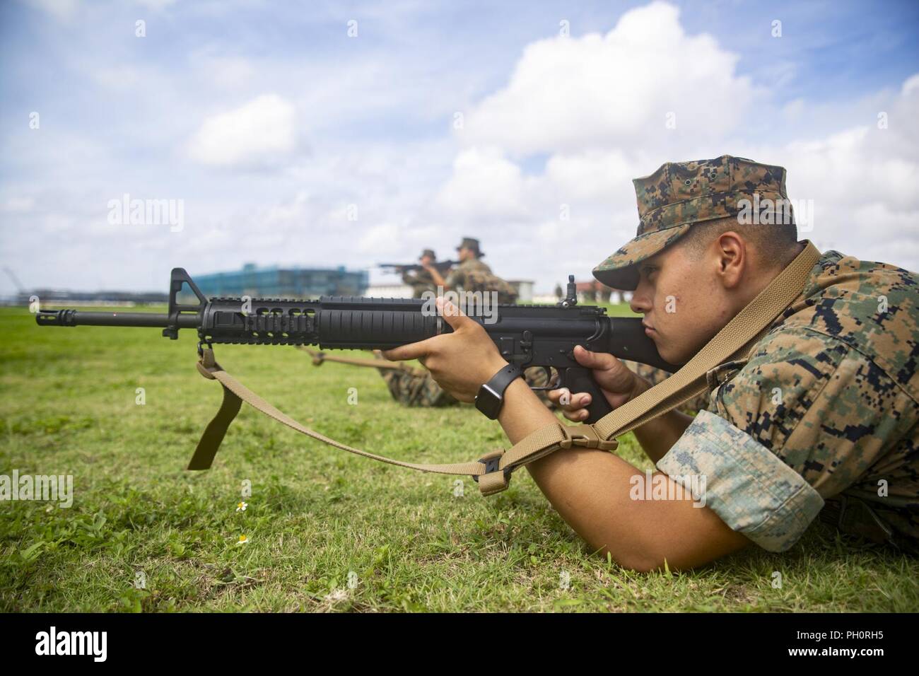 Lance Cpl. Erik Floresdelamora, a food service specialist with Food Service Company, Headquarters Regiment, 3rd Marine Logistics Group, sights in during the Battle Skills Test June 20, 2018, at Camp Kinser, Okinawa, Japan. Marines practiced buddy rushes, ambush drills and air attack drills among other counter attacks that may be used during combat scenarios. During the BST, Marines are tested on different skills such as operating a radio, applying tourniquets and handing detainees. Floresdelamora is a native of Kansas City, Kansas. Stock Photo