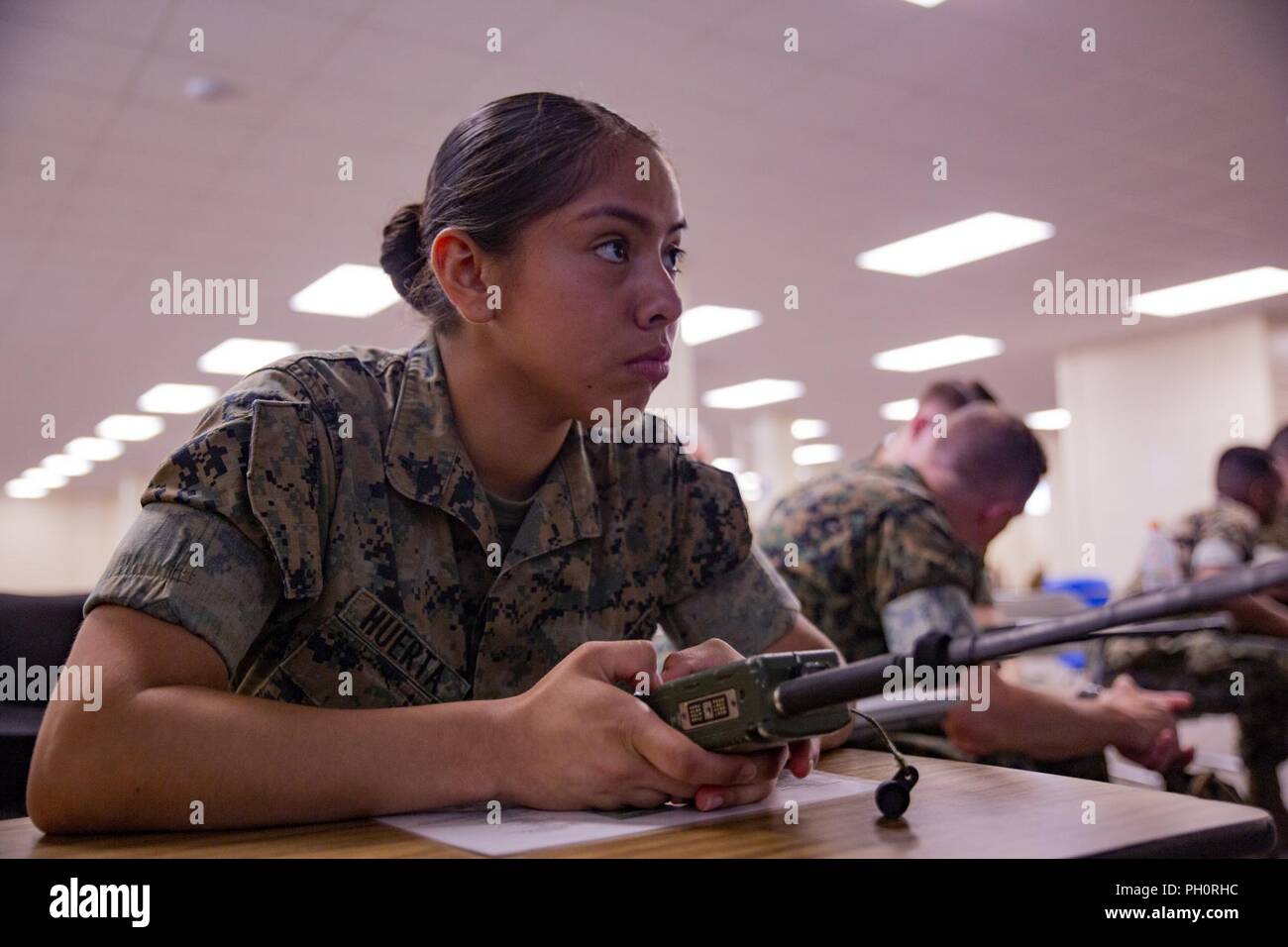 Lance Cpl. Roxanna Huerta, a food service specialist with Food Service Company, Headquarters Regiment, 3rd Marine Logistics Group, practices working on an AN-PRC 152 radio during the Battle Skills Test June 20, 2018, at Camp Kinser, Okinawa, Japan. During the BST, Marines are tested on different skills such as operating a radio, applying tourniquets and handling detainees. Huerta is a native of San Bernardino, California. Stock Photo