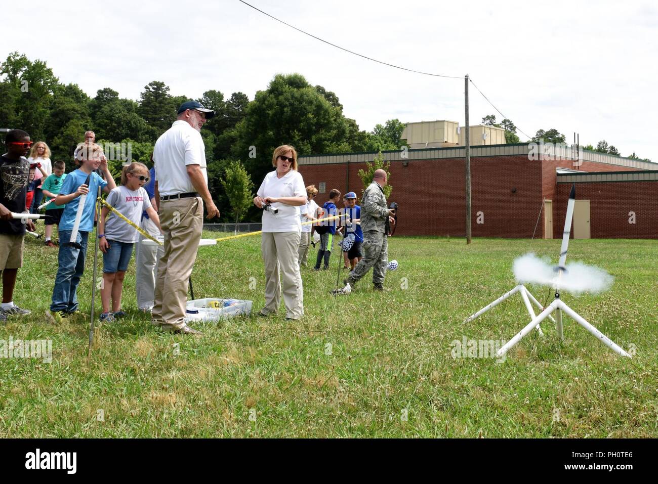 Parents, campers, and teachers watch as model rockets launch near Reid Park Academy Charlotte, N.C., June 21, 2018. The campers and teachers are part of the annual Department of Defense STARBASE summer camp program with the North Carolina Air National Guard and they learn various applications of science, technology, engineering, and math. Stock Photo