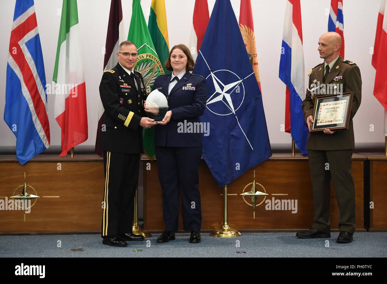 upreme Allied Commander Europe (SACEUR), General Curtis M. Scaparrotti, and Command Senior Enlisted Leader (CSEL), Command Sergeant Major Davor Petek, present U.S. Air Force Captain Amanda Zenner with the ACO Military Member of the Year Award on Thursday, June 21, 2018 at Allied Joint Force Command Naples. Stock Photo