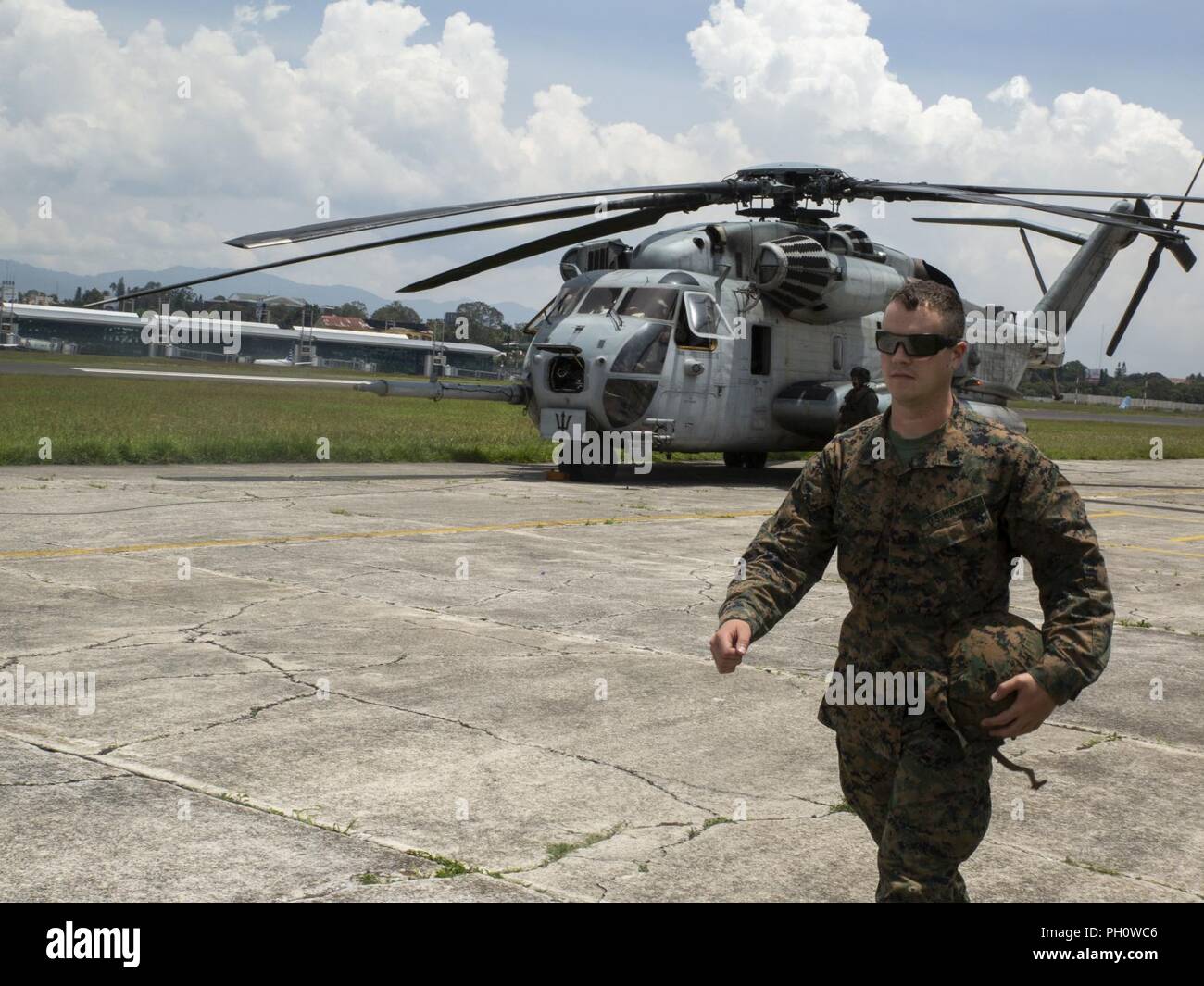 U.S. Marine Sgt. Erik Demay, the Marine Corps Community Services chief with Special Purpose Marine Air-Ground Task Force - Southern Command, walks off the flight line to check into the immigration office in Guatemala City, Guatemala, June 20, 2018. Leaders with SPMAGT-SC visited Marines and sailors in Puerto Barrios and Flores, Guatemala, to deliver supplies and check on the welfare of the troops.  The Marines and sailors of SPMAGTF-SC are conducting security cooperation training and engineering projects alongside partner nation military forces in Central and South America. The unit is also on Stock Photo