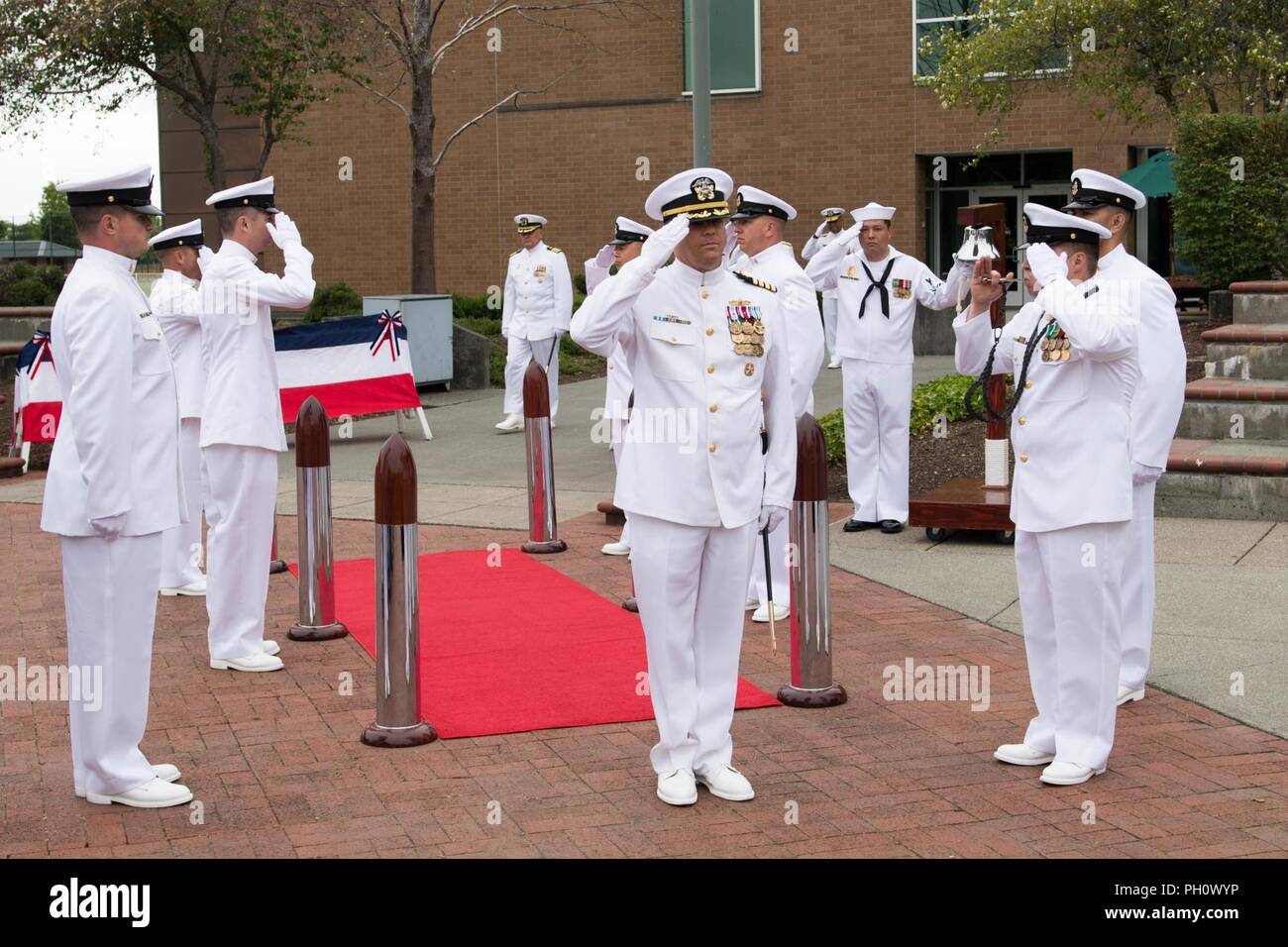 Everett, Wash. (June 22, 2018) Capt. Mike Davis, incoming commanding officer of Naval Station Everett (NSE), is piped aboard during the arrival of the official party at a change of command ceremony. During the ceremony Davis relieved Capt. Mark Lakamp as commanding officer of NSE. Stock Photo