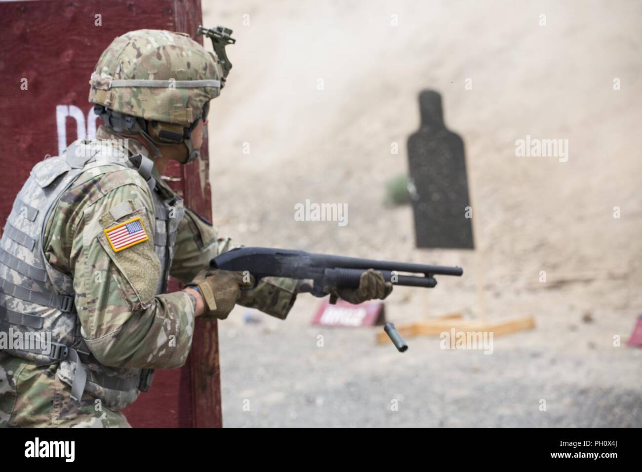 Spc. Corey Adams with Alpha Company, 1st Battalion, 161st Infantry Regiment, 81st Stryker Brigade Combat Team fires an M500 shotgun during short range marksmanship training at the Yakima Training Center, Yakima, Wash. June 21, 2018.  Short range marksmanship training helps soldiers increase their accuracy in urban combat situations. Stock Photo
