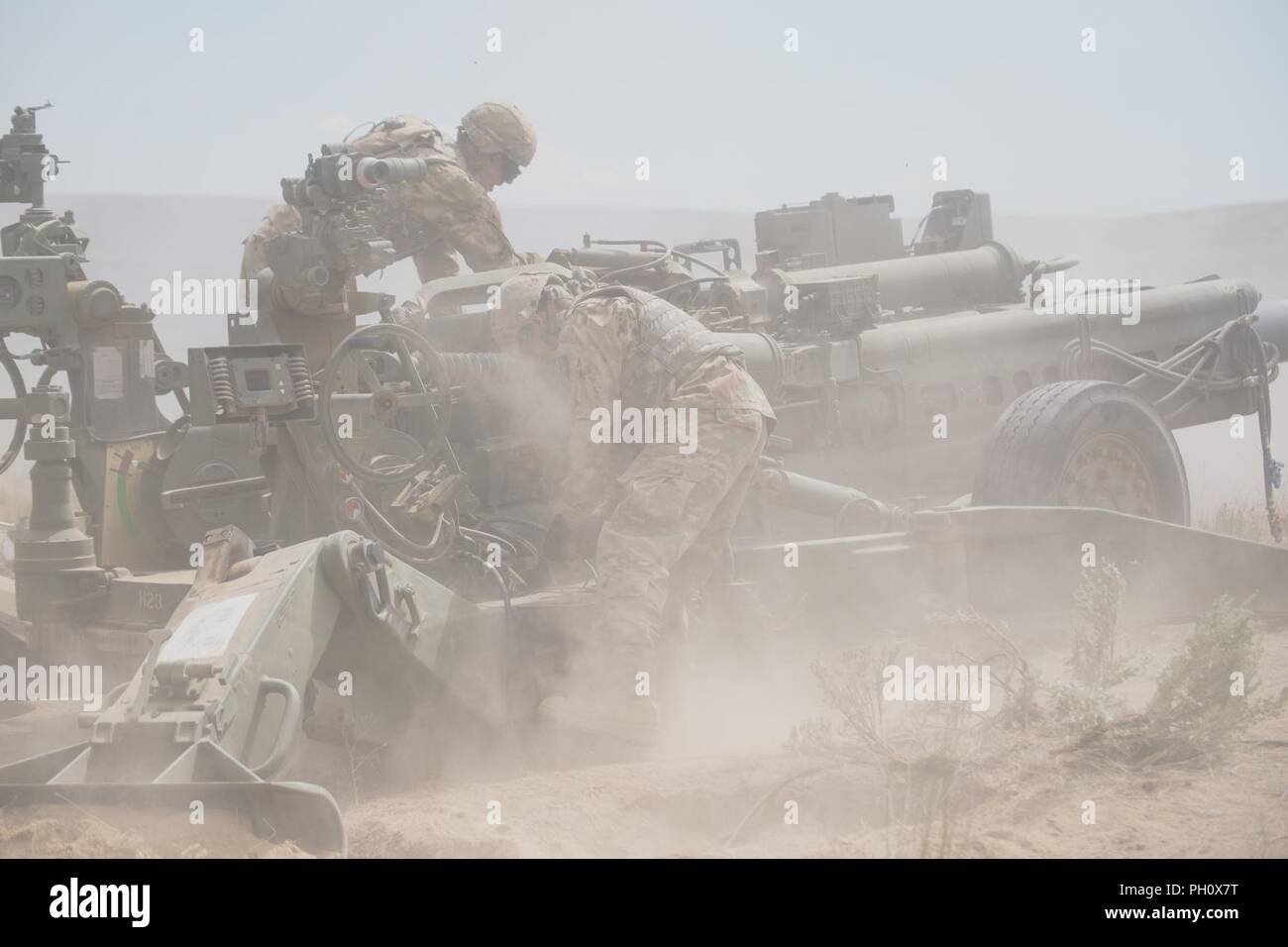 Soldiers with 2nd Battalion, 146th Field Artillery Regiment, 81st Stryker Brigade Combat Team, prepare to fire an M777 howitzer after performing a live fire mission at the Yakima Training Center, Yakima, Wash., June 21, 2018. Stock Photo