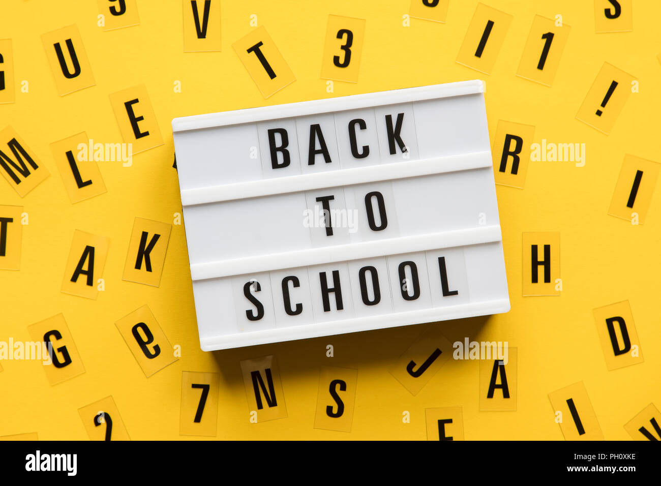 Back to school lightbox message on a bright yellow background Stock Photo