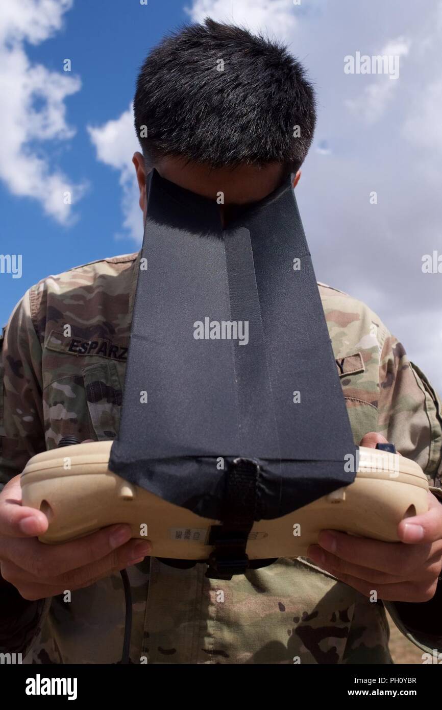 U.S. Army Spc. Justin Esparza, a military police Soldier with the 552nd Military Police Company, operates an RQ-11 Raven unmanned aerial vehicle June 24, 2018, during Khaan Quest 2018 at Five Hills Training Area, Mongolia. Exercises like Khaan Quest contribute to a regional peacekeeping capability in Asia, which in turn fosters important worldwide peacekeeping operations. Stock Photo