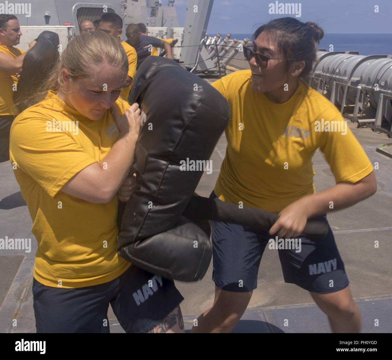 MEDITERRANEAN SEA (June 21, 2018) Ensign Genelle Arandia, from Gainesville, Florida, and Ensign Jenna Padgett, from Live Oak, Florida, practice proper baton use during security reaction force basic training aboard the San Antonio-class amphibious transport dock ship USS New York (LPD 21) June 21, 2018. New York, homeported in Mayport, Florida, is conducting naval operations in the U.S. 6th Fleet area of operations in support of U.S. national security interests in Europe and Africa. Stock Photo