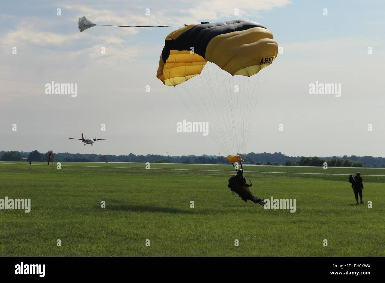 A U.S. Army Parachute Team tandem instructor and his nominee prepare to