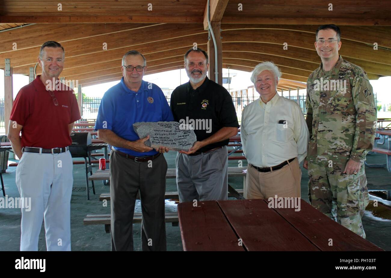 From left, Eddie Somers, president, Smith Island United; Randy Laird, president, Somerset County Commissioners; Mark Belton, Maryland Natural Resources secretary; Charles Halm, director, Community Planning and Development, U.S. Department of Housing and Urban Development, Baltimore Field Office; and Col. Ed Chamberlayne, commander, U.S. Army Corps of Engineers, Baltimore District, present a piece of jetty stone signed by the officials following a ceremony at Crisfield's Somers Cove Marina celebrating the completion of two jetties and a stone sill as part of a navigation improvement project at  Stock Photo