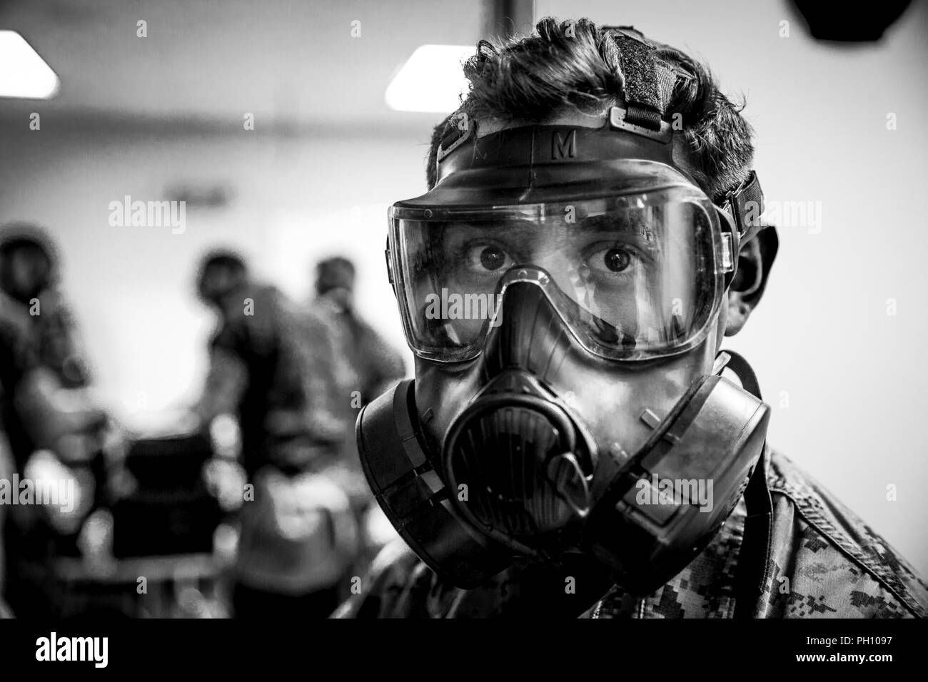 U.S. Marine Corps Lance Cpl. Guerrero, a chemical, biological, radiological, and nuclear (CBRN) defense specialist with CBRN Platoon, Headquarters Battalion, 1st Marine Division, poses for a picture during the Concept of Real World CBRN Operations course at the Guardian Centers in Perry, Georgia, June 20, 2018. This training was conducted to enhance and refine the conduct of sensitive site exploitation, which supports the commander’s decision making cycle and maintains momentum during combat operations. Stock Photo